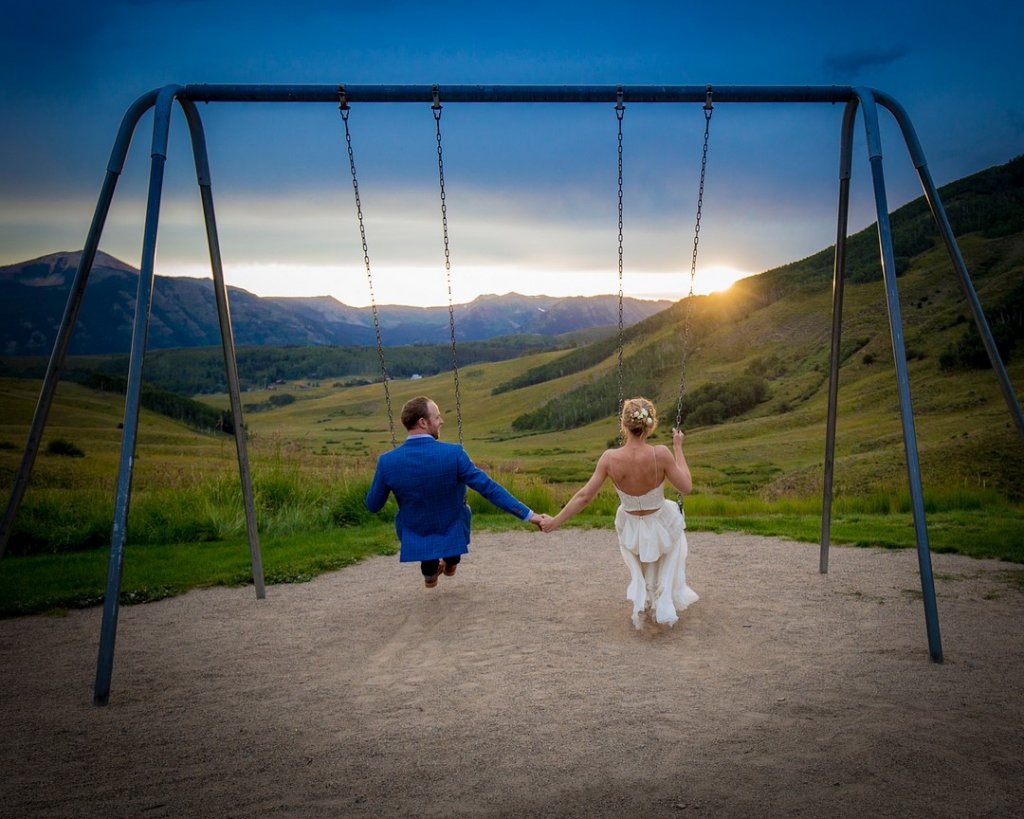 bride and groom on swings