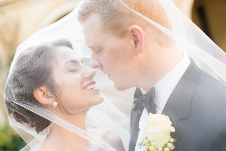 bride and groom through the wedding veil