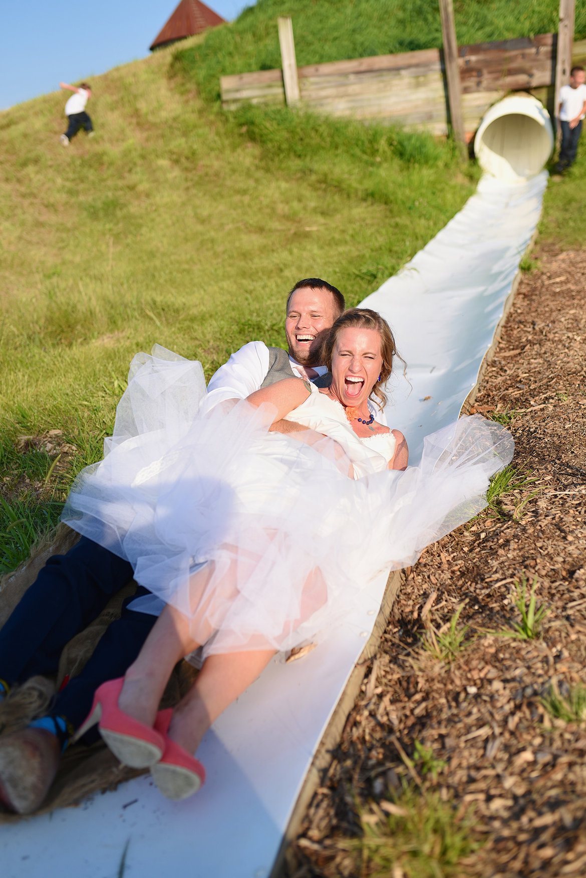 bride and groom on slide