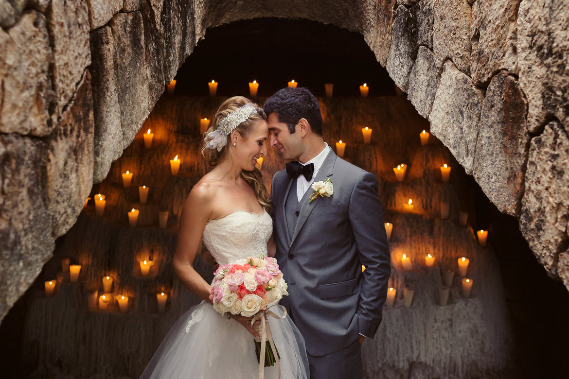 bride and groom with candle backdrop