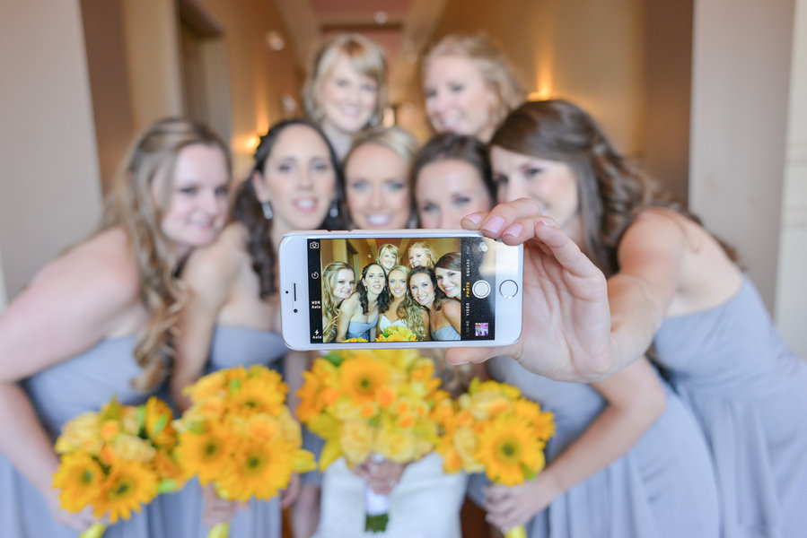 bride and bridesmaids taking a selfie