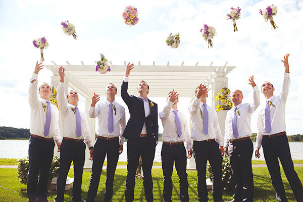 groom and groomsmen tossing the bouquets