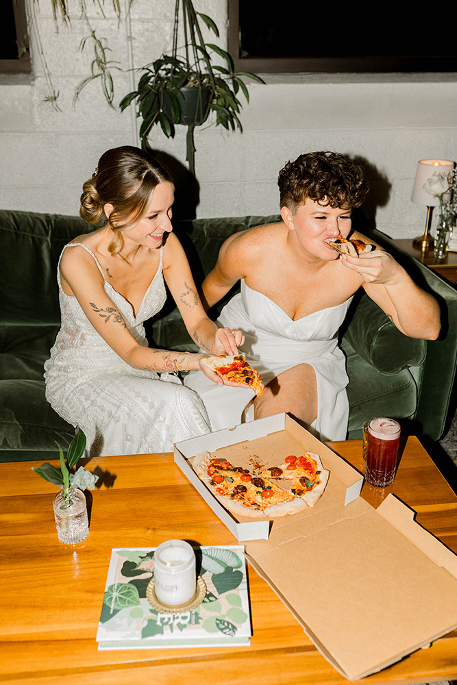 two brides eating pizza
