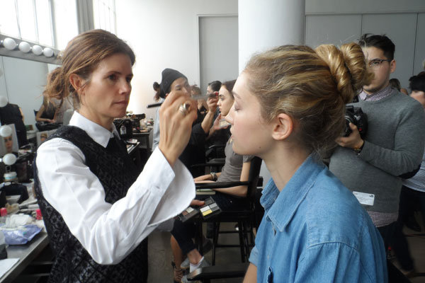 gucci westman applying eye makeup to model 