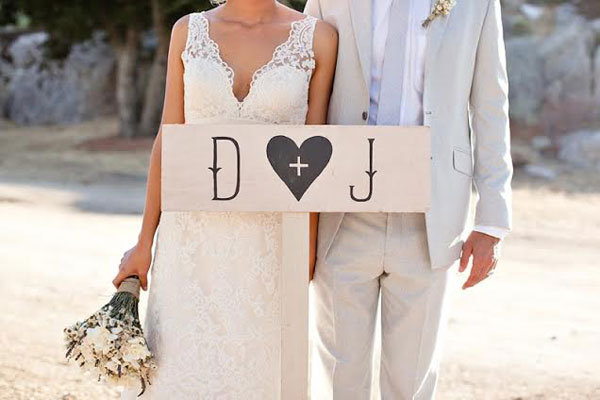 couple with rustic initial sign