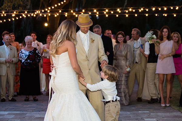 bride and groom dancing with son