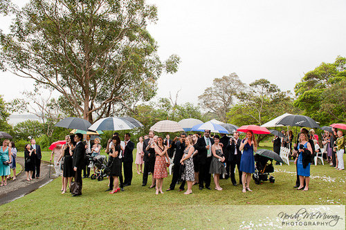 wedding guests with umbrellas