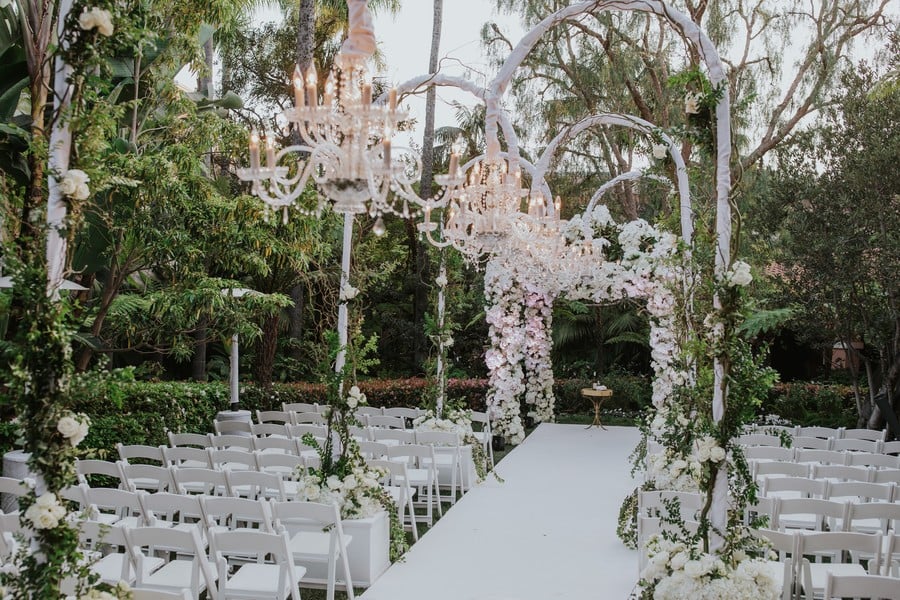 Chandeliers over wedding ceremony aisle