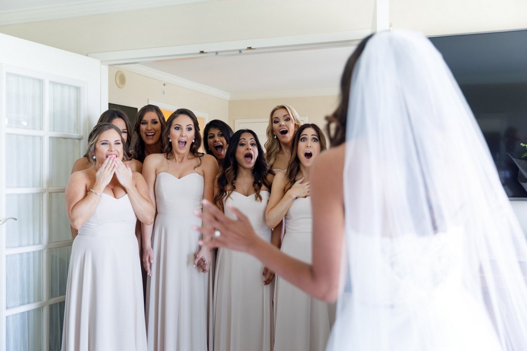 Bridesmaids reaction to bride in wedding gown