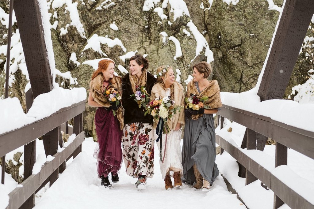 winter wedding bride and bridesmaids in snow