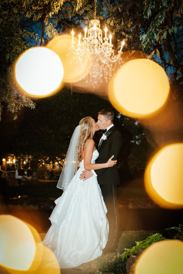 Romantic lighting bride and groom kiss