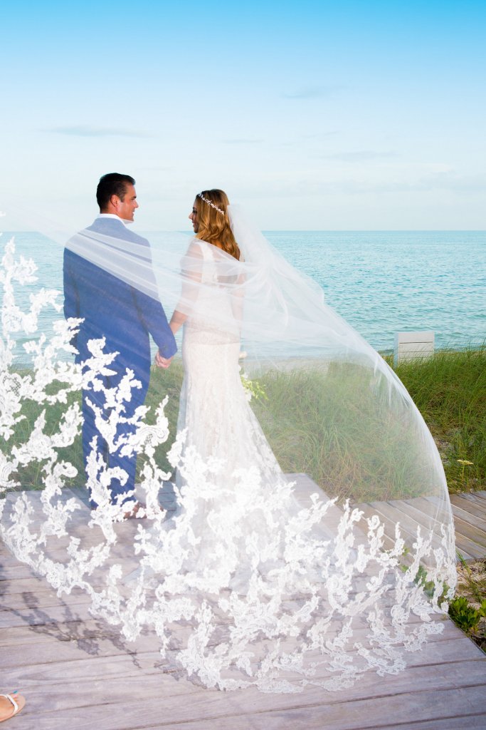 Couple wrapped in brides veil