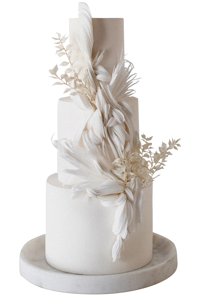Three-tier feather-accented cake by Hey there, Cupcake