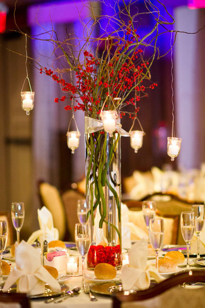 red flower centerpiece with candles 