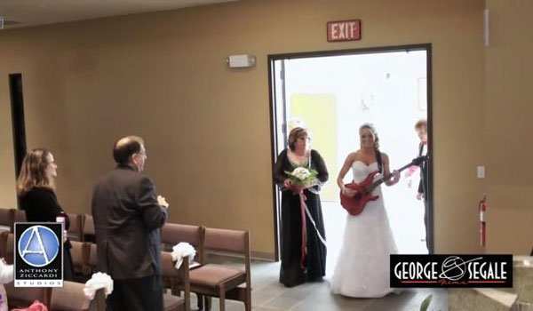 bride playing guitar down the aisle