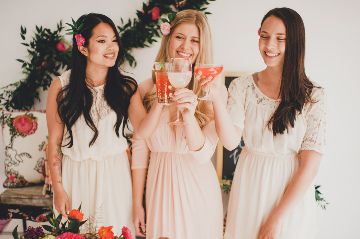 bride and bridesmaids toasting