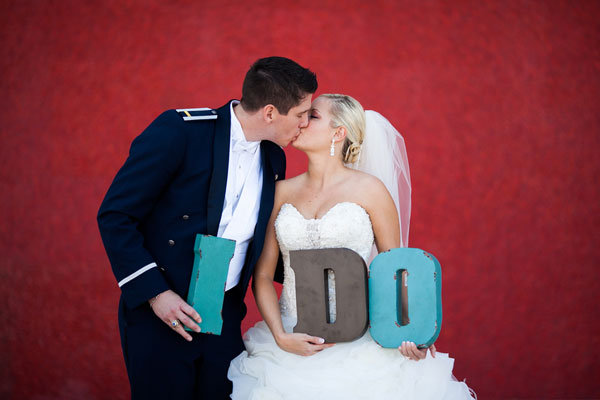bride and groom with i do sign 