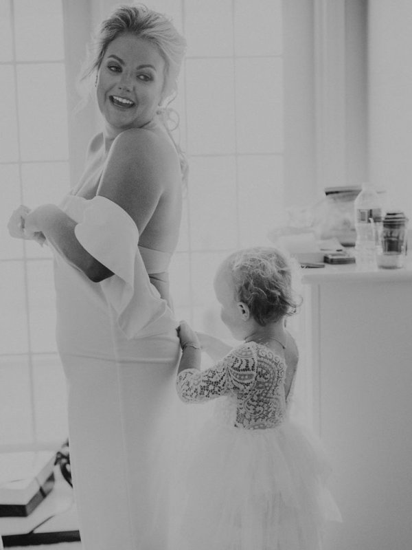 bride and flower girl getting ready for wedding