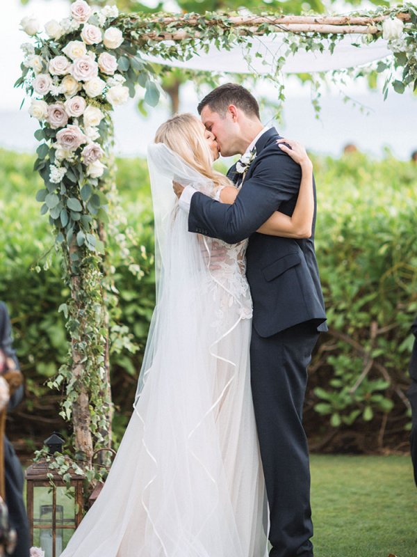 Bride and groom kissing at wedding ceremony