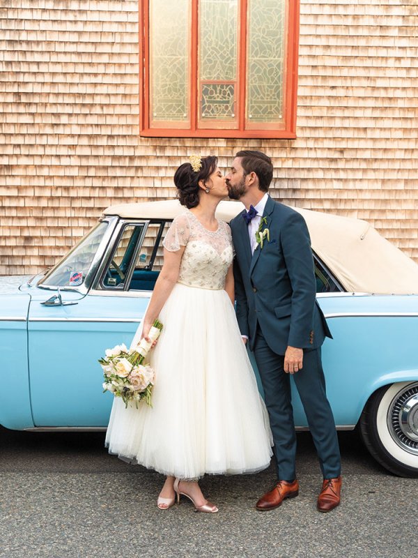 Bride and groom with vintage car