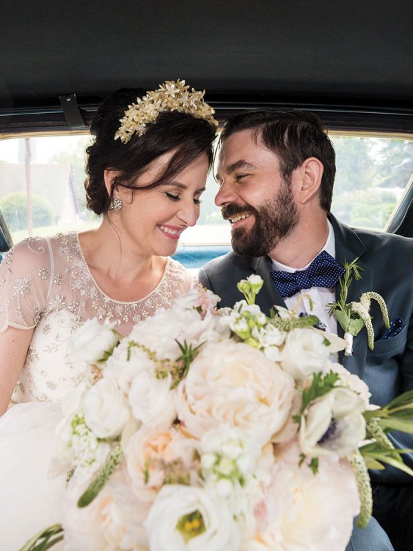 Bride and groom in getaway car