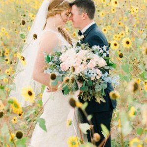 Bride and groom in a sunflower field