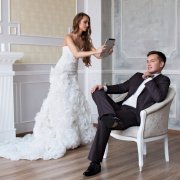 bride taking picture of groom