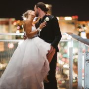 Bride and groom kissing on balcony