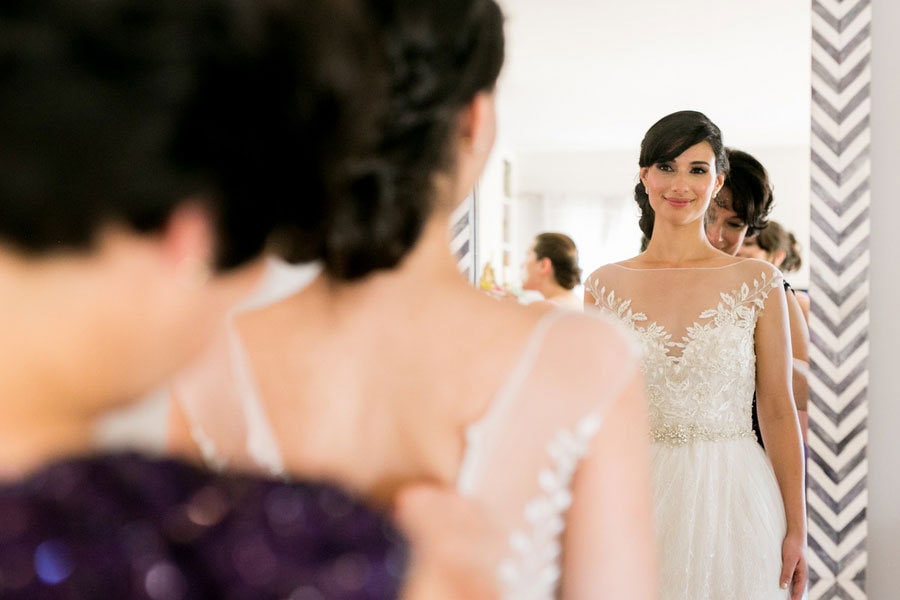Elegant bride trying on wedding dress in bridal boutique, wedding dress fitting, bridal fashion.