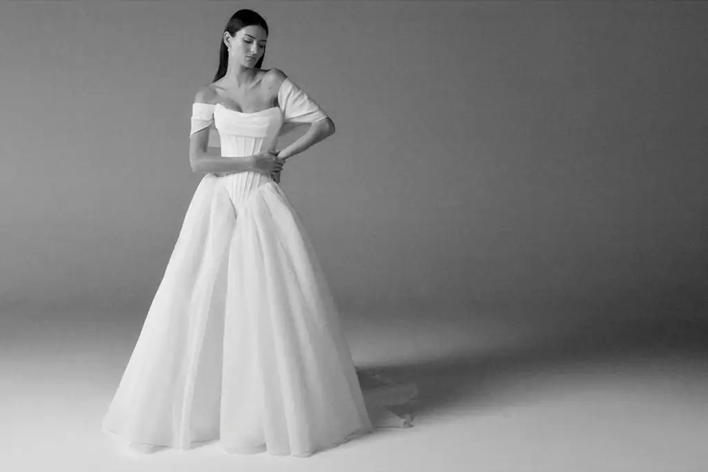 Elegant bridal gown with off-shoulder design for wedding day.