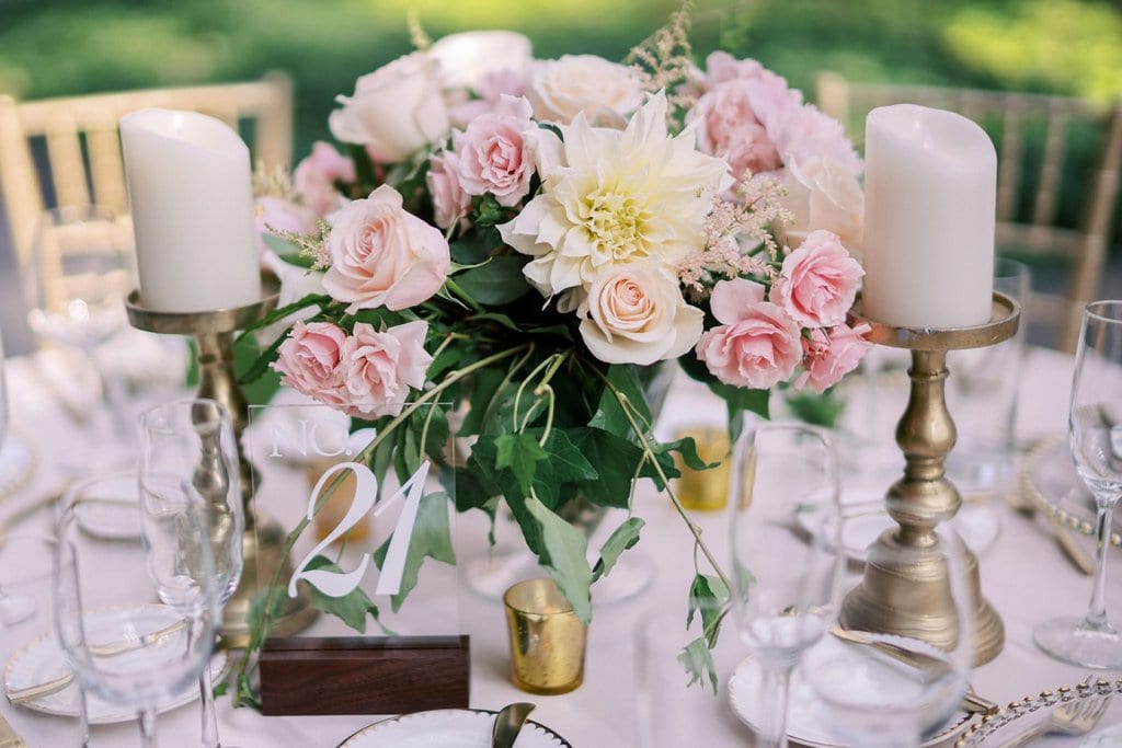 Elegant floral bridal centerpiece with candles for wedding decor.
