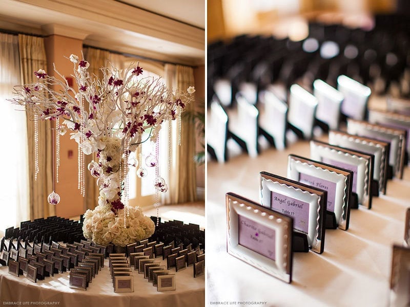 Elegant wedding ceremony decor with floral arrangements and framed programs.