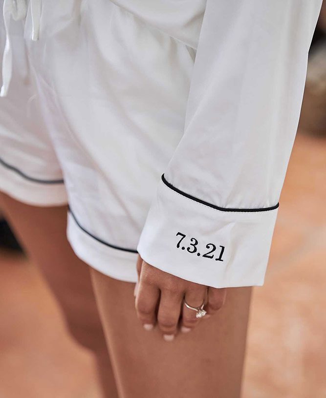 Bridal satin pajamas with date "7.3.21" embroidered on sleeve, cozy wedding morning attire.