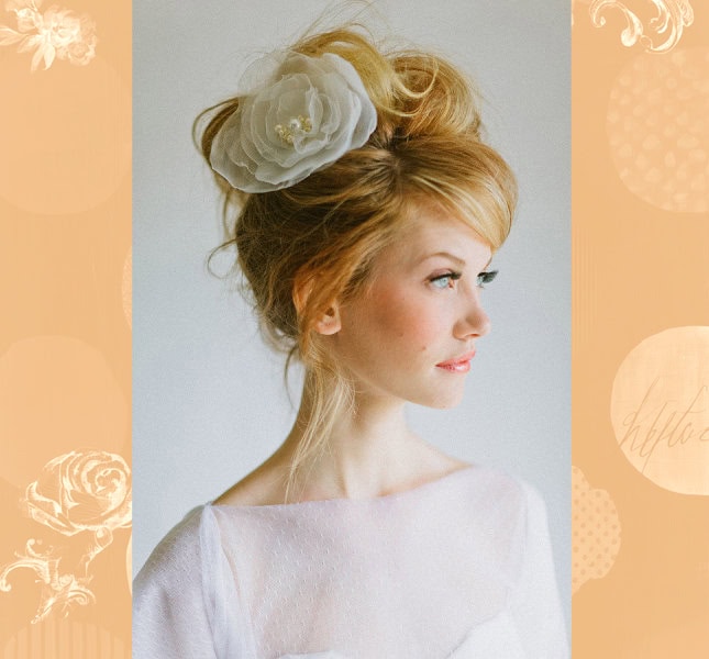Elegant bridal hairstyle with floral hair accessory for wedding day.